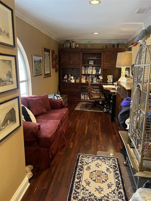 office featuring dark wood-type flooring, ornamental molding, and built in desk