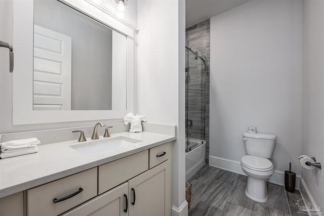 full bathroom featuring combined bath / shower with glass door, vanity, and toilet