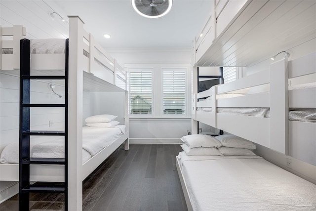 bedroom featuring crown molding and dark hardwood / wood-style floors