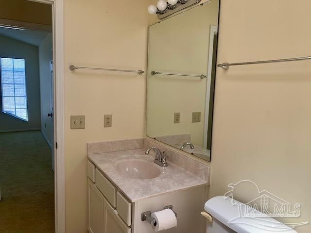 bathroom featuring vanity and toilet