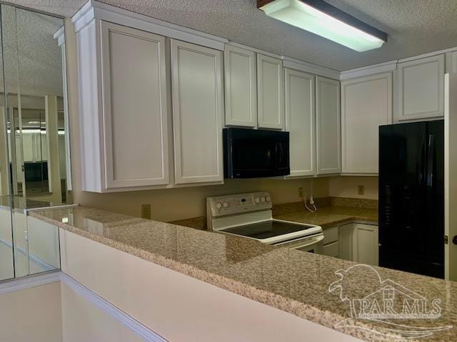 kitchen with black appliances, a textured ceiling, and white cabinets