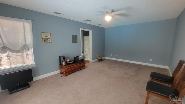 sitting room with light colored carpet and ceiling fan