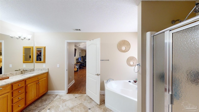 bathroom with plus walk in shower, a textured ceiling, vanity, and an inviting chandelier