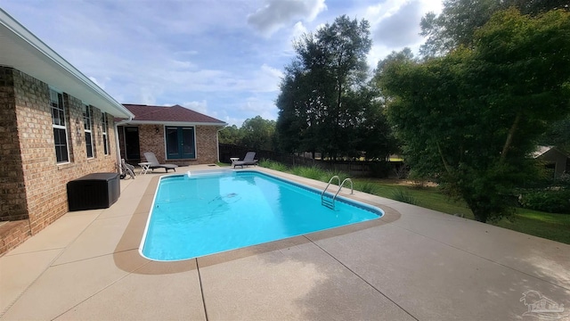 view of pool featuring a patio