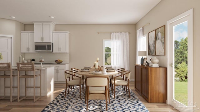 dining room featuring recessed lighting and light wood-style floors