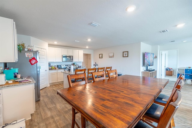 dining area with light wood-type flooring