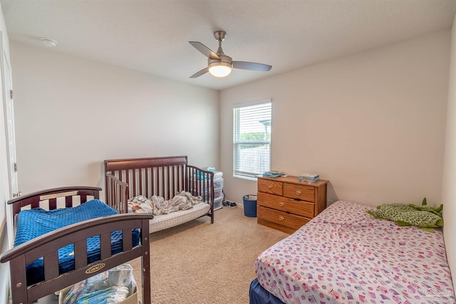 carpeted bedroom with ceiling fan