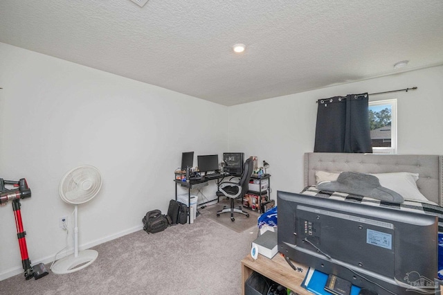 bedroom featuring light carpet, baseboards, and a textured ceiling