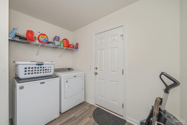 laundry room featuring laundry area, independent washer and dryer, and wood finished floors