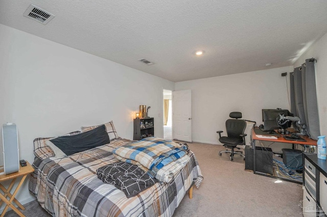 carpeted bedroom featuring visible vents and a textured ceiling