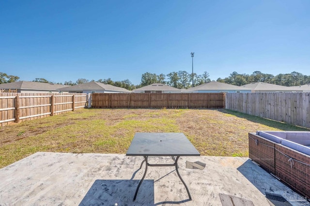 view of yard featuring a patio area and a fenced backyard