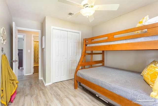 bedroom featuring ceiling fan, a closet, and light hardwood / wood-style floors