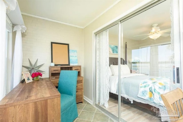 bedroom featuring ceiling fan, tile patterned floors, and a closet