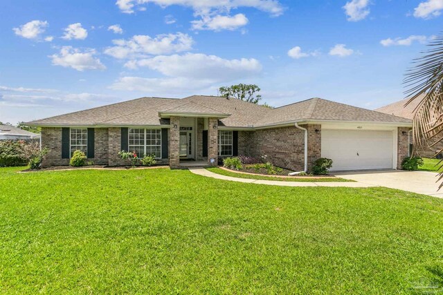 4803 Jaimee Leigh Dr, Milton, FL 32570 - view of front of home with an attached garage, brick siding, concrete driveway, and a front yard