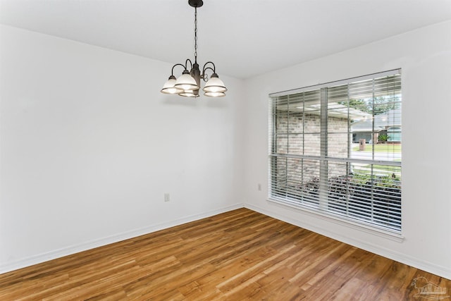 4803 Jaimee Leigh Dr, Milton, FL 32570 - unfurnished room with a chandelier, light wood-style flooring, and baseboards
