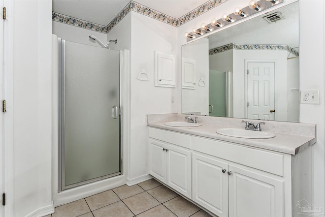 4803 Jaimee Leigh Dr, Milton, FL 32570 - full bath with a stall shower, tile patterned flooring, double vanity, and baseboards
