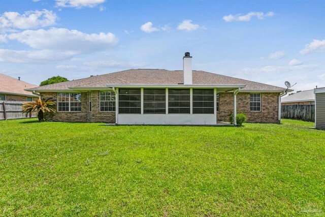 4803 Jaimee Leigh Dr, Milton, FL 32570 - back of house featuring a chimney, brick siding, a sunroom, and roof with shingles