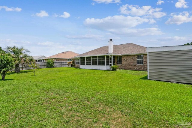 4803 Jaimee Leigh Dr, Milton, FL 32570 - rear view of property with a sunroom, brick siding, and a chimney
