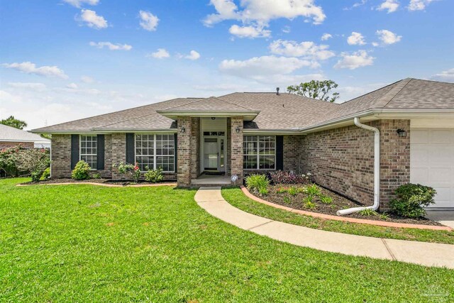 4803 Jaimee Leigh Dr, Milton, FL 32570 - view of front facade with brick siding, an attached garage, a front yard, and a shingled roof