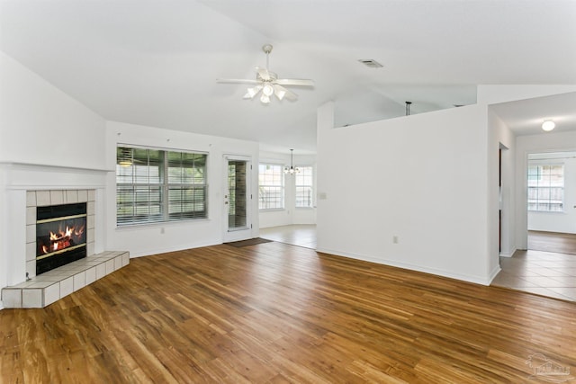 4803 Jaimee Leigh Dr, Milton, FL 32570 - unfurnished living room featuring a fireplace, ceiling fan, lofted ceiling, plenty of natural light, and wood finished floors