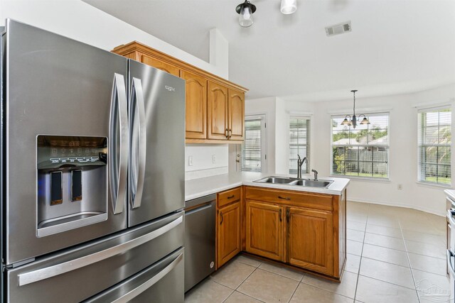 4803 Jaimee Leigh Dr, Milton, FL 32570 - kitchen with appliances with stainless steel finishes, a sink, a peninsula, light countertops, and brown cabinetry
