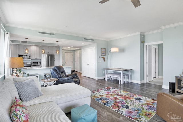 living area featuring ornamental molding, ceiling fan, baseboards, and dark wood finished floors