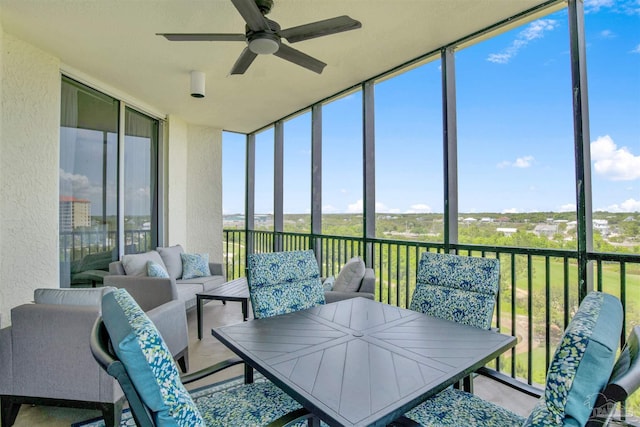 sunroom / solarium featuring a ceiling fan and an outdoor living space
