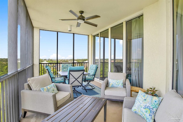sunroom featuring a ceiling fan, an outdoor hangout area, and healthy amount of natural light