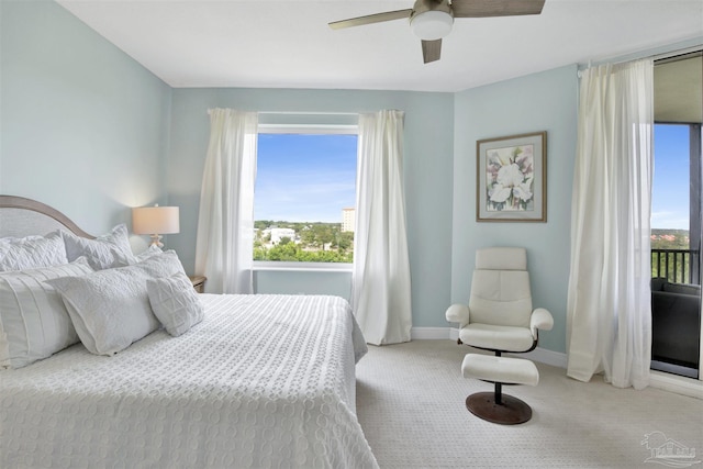 bedroom featuring carpet floors, multiple windows, baseboards, and a ceiling fan