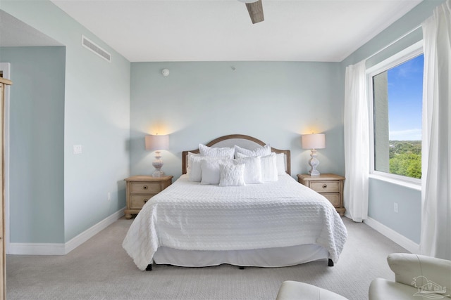bedroom with light colored carpet and baseboards