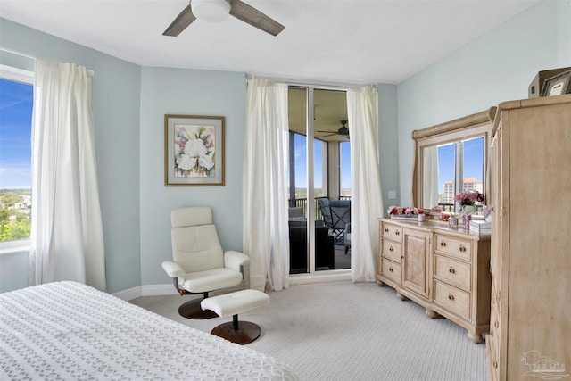 bedroom featuring light colored carpet, access to outside, and a ceiling fan