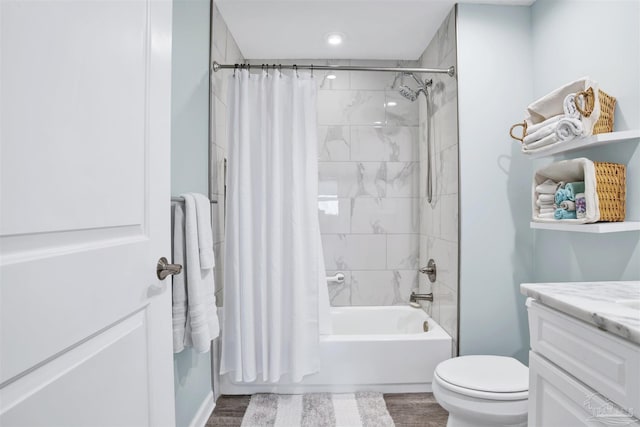 bathroom featuring shower / tub combo, wood finished floors, vanity, and toilet