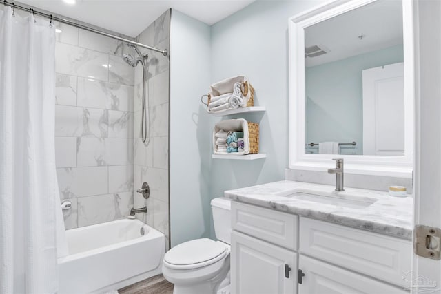bathroom featuring toilet, shower / bath combination with curtain, vanity, and wood finished floors