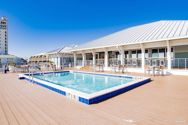 community pool with a wooden deck
