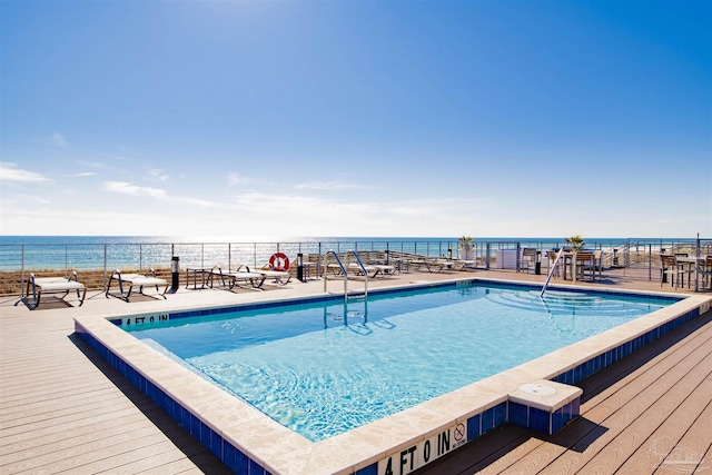 community pool featuring fence and a water view