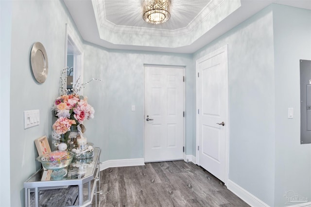 foyer entrance with wood finished floors, baseboards, and a chandelier