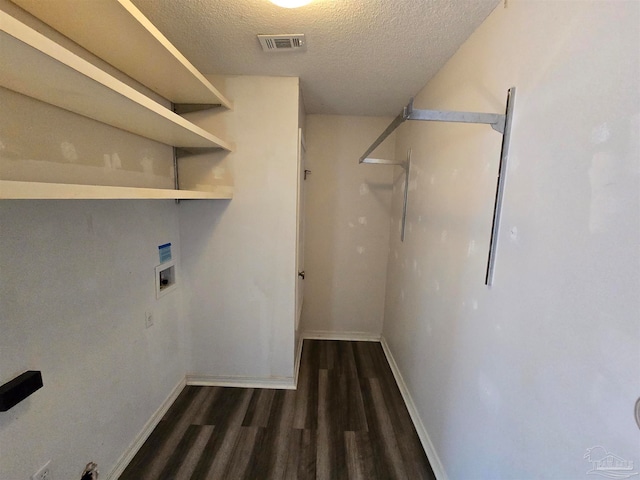 laundry area featuring hookup for a washing machine, a textured ceiling, and dark hardwood / wood-style floors