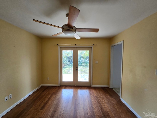 empty room featuring dark hardwood / wood-style flooring, ceiling fan, and french doors