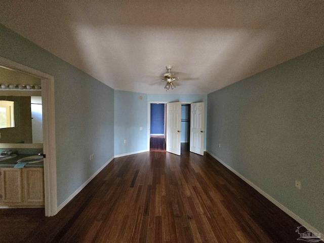 unfurnished room with ceiling fan and dark wood-type flooring