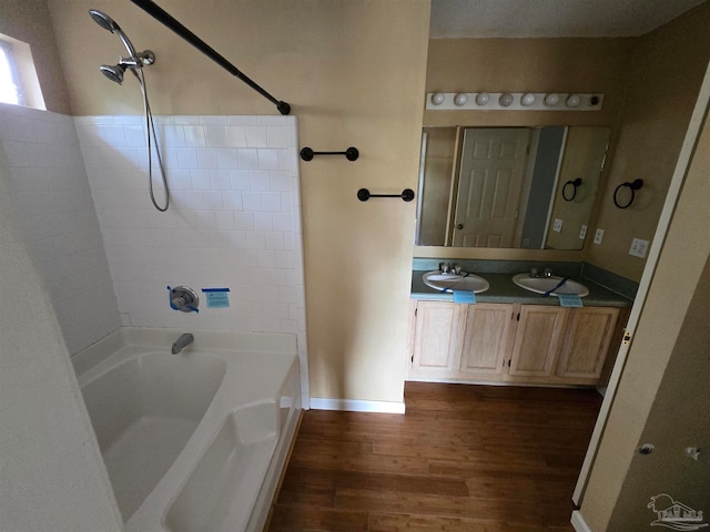 bathroom featuring vanity, hardwood / wood-style floors, and shower / tub combination