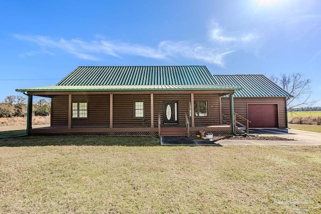 log cabin featuring a front lawn, covered porch, and a garage