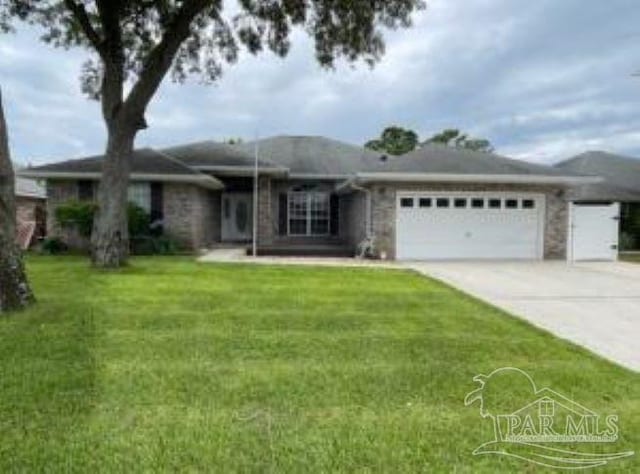 2682 Shoni Dr, Navarre, FL 32566 - single story home featuring a garage, driveway, and a front lawn