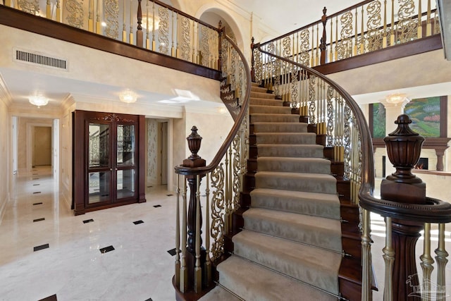 721 W Miracle Strip Pkwy, Mary Esther, FL 32569 - staircase with visible vents, french doors, a towering ceiling, and ornamental molding