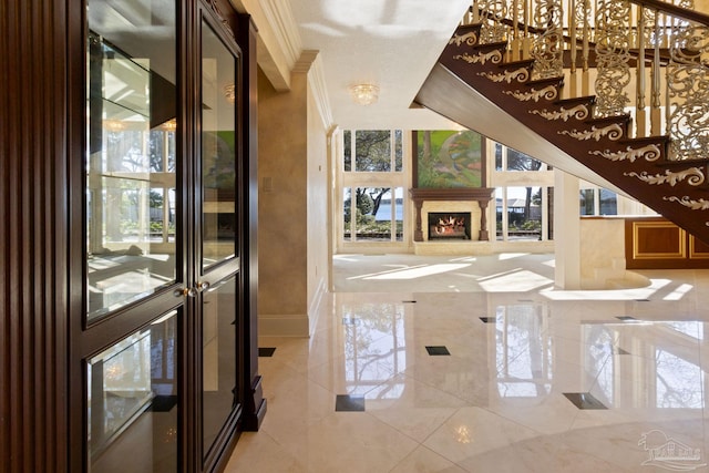 721 W Miracle Strip Pkwy, Mary Esther, FL 32569 - entrance foyer featuring a fireplace, baseboards, a wealth of natural light, and ornamental molding
