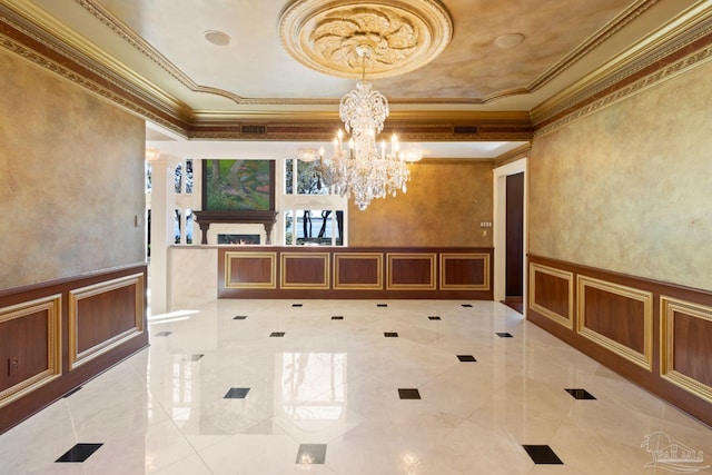 721 W Miracle Strip Pkwy, Mary Esther, FL 32569 - interior space with crown molding, a decorative wall, a notable chandelier, and a wainscoted wall