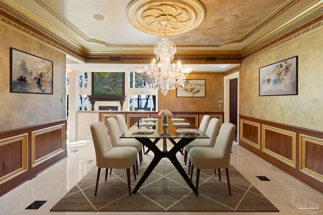 721 W Miracle Strip Pkwy, Mary Esther, FL 32569 - dining area featuring a notable chandelier, a decorative wall, wainscoting, and ornamental molding