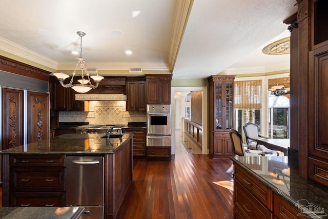 721 W Miracle Strip Pkwy, Mary Esther, FL 32569 - kitchen with dark wood-style floors, ornamental molding, stainless steel oven, a warming drawer, and a chandelier