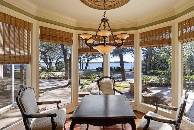 721 W Miracle Strip Pkwy, Mary Esther, FL 32569 - sunroom / solarium featuring ornamental molding, a notable chandelier, a water view, and plenty of natural light