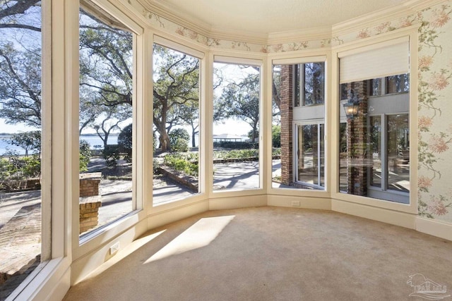 721 W Miracle Strip Pkwy, Mary Esther, FL 32569 - unfurnished sunroom with ornamental molding, wallpapered walls, and carpet floors