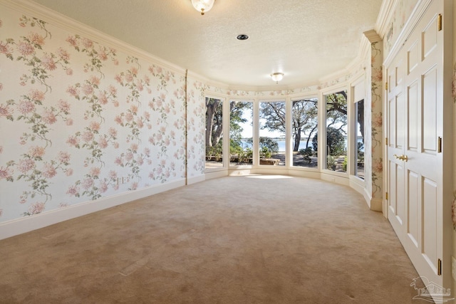 721 W Miracle Strip Pkwy, Mary Esther, FL 32569 - spare room with ornamental molding, a textured ceiling, wallpapered walls, and carpet floors